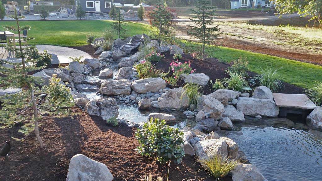 Image of a rock pond and babbling book, one of Frontier's landscaping installation projects.